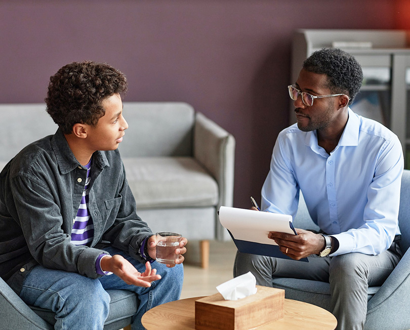 boy talking to adolescent psychologist