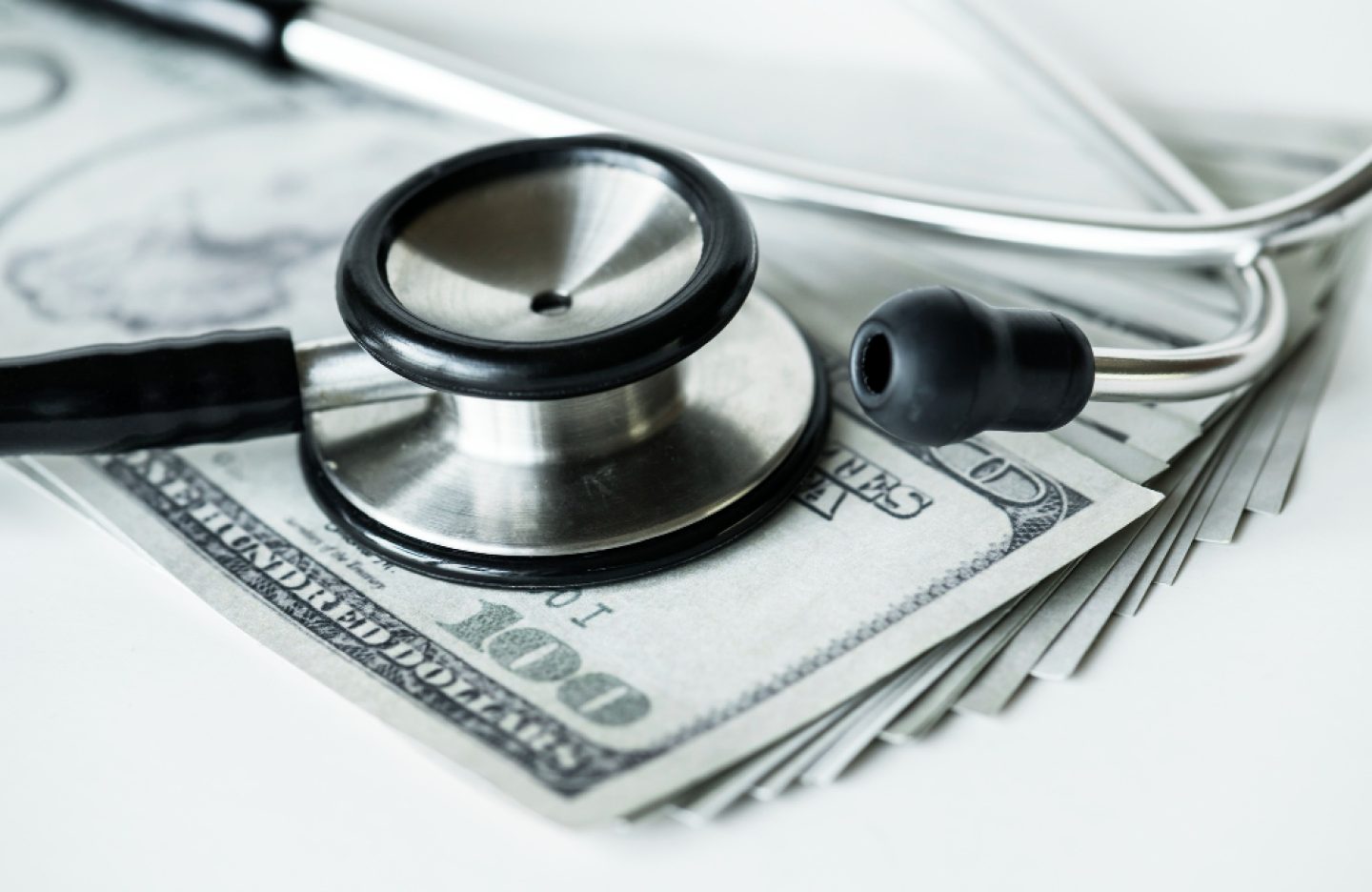 closeup-cash-stethoscope-healthcare-expenses-concept